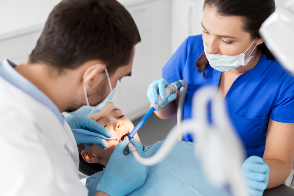 dental assistants working with patient